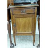 A 1920s mahogany bedside cabinet with a drawer and panelled door,