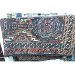 A Persian rug with stylised designs on a multi-coloured ground 34'' x 60'' S