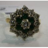 An 18ct gold claw set emerald and diamond cluster ring 11