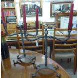 A pair of rustically constructed, wrought iron, twin branch candelabra,