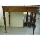 An early 19thC mahogany tea table with a rotating foldover top, raised on ring turned,