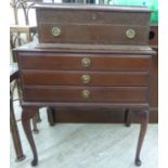 A modern mahogany finished three drawer canteen,