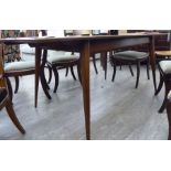 A 1970s teak extending dining table, the top with a moulded edge,
