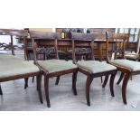 A set of six Regency mahogany framed bar back dining chairs with carved splats and green fabric