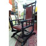 A late 19thC American design ebonised hardwood framed rocking chair with a red faux hide