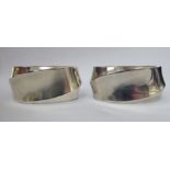 A pair of Continental silver coloured metal napkin rings of oval,