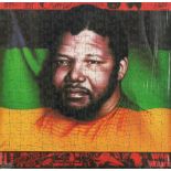 War on Want Jigsaw Puzzle. NELSON MANDELA AND THE ANC FLAG. Design by Paul Morton. Colour photograph