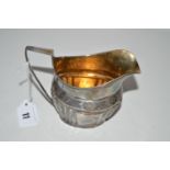 A Georgian silver helmet form cream jug, London 1807, gilt interior,