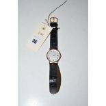 A 9ct. gold cased Citizen quartz wristwatch on leather strap.