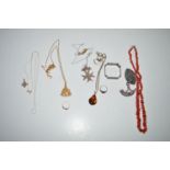 A coral necklace; a silver napkin ring; a silver brooch; various items of costume jewellery; etc.