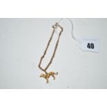 A yellow metal bracelet, of twisted links mounted with a yellow metal lurcher pattern charm,