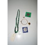 A malachite bead necklaces; together with a bangle; a locket pendant; two coins; and a ring.