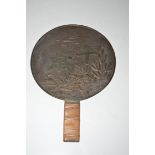 A Japanese bronze mirror, 20th Century, decorated on one side with cranes and characters.