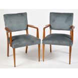 A pair of late 20th Century teak open armchairs, with upholstered backs and seats, each 90cms high.