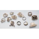Thirteen silver rings of various designs.