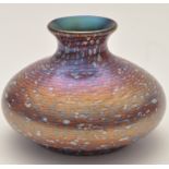 Okra: an iridescent circular squat vase, flared rim, red and purple decoration,