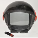 A Phillips Discoverer Television of space helmet form, on wheels, together with remote.