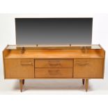 William Lawrence, Nottingham: a teak dressing table, the mirror back above a glazed shelf,