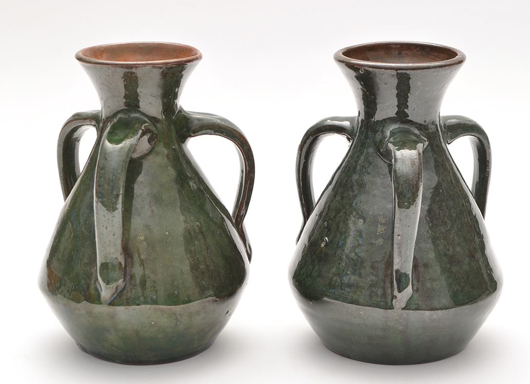 Burmantoft: two Art Nouveau style three-handled vases with green glaze,