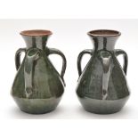 Burmantoft: two Art Nouveau style three-handled vases with green glaze,