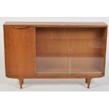 A late 20th Century teak side cabinet, with sliding glass doors and a solid door,