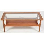 A 1970's teak coffee table, the glazed top above an undertier, 115 x 46 x 45cms high.