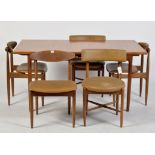 Ib Kofod-Larsen for G-Plan: a teak draw leaf dining table,