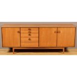 A 1970's teak sideboard, fitted drawers and three cupboard doors, 201 x 48 x 76cms high.