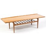 A 1970's teak coffee table, the rectangular top above slatted undertier, 161 x 56 x 44cms high.
