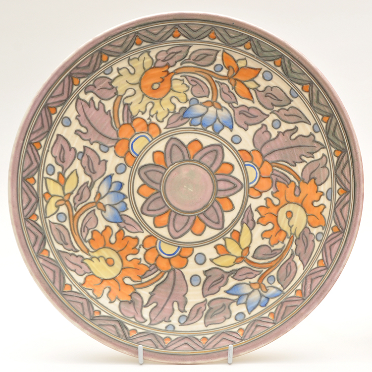 Charlotte Rhead for Crown Ducal: a circular wall plaque with floral decoration,