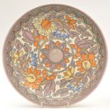 Charlotte Rhead for Crown Ducal: a circular wall plaque with floral decoration,