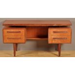 G-Plan: a teak desk, the rectangular top above two pairs of drawers, raised on tapering legs,