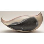 Ray Rogers: an abstract sculpture of fluid form, mottled red, blue and cream glaze, incised,