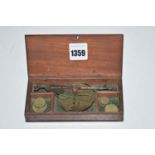 An early 19th Century set of miniature scales, in fitted mahogany box, some brass weights.