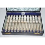 Twelve fruit knives and forks, by Walker & Hall, with silver filled handles, in fitted case.