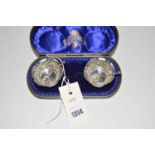 A pair of silver table salts, E.J.H. N.H., Chester 1907, with associated spoons, in fitted case.