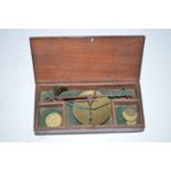 An early 19th Century set of miniature scales, in fitted mahogany box, some brass weights.