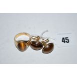 A gentleman's ring, set oval tiger's eye cabochon, in yellow metal stamped '9k 375',