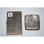 An Art Deco silver cigarette case of engine turned design; together with another cigarette case.