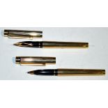 Two Sheaffer pens, in gold electro plated cases, one a fountain pen fitted 14ct.