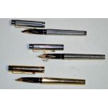 Three Sheaffer fountain pens, two in silver plated chequer-cut cases,