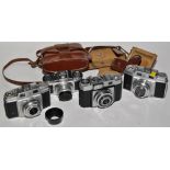 A Braun Paxette rangefinder camera; two Agfa Super Silette rangefinder cameras;