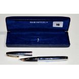 A Sheaffer fountain pen, in white plated metal case, fitted 14ct. gold nib, cased.