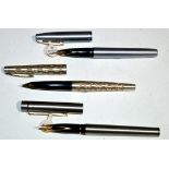 Three Sheaffer fountain pens, two in matte steel cases,