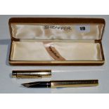 A Sheaffer Targa fountain pen, in square cut gold coloured electroplate case, fitted 14ct.