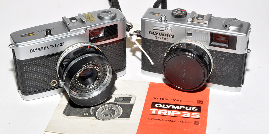 An Olympus 35RC rangefinder camera; and an Olympus Trip 35 camera.
