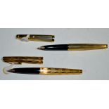 Two Sheaffer fountain pens in gold plated cases, one with zigzag design, the other plain,