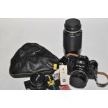 A Nikon EM SLR camera with E-series 28mm, 50mm and 70-210mm lenses.