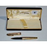 A Sheaffer fountain pen, in yellow electroplated metal chequer cut case, fitted 14ct. gold nib.