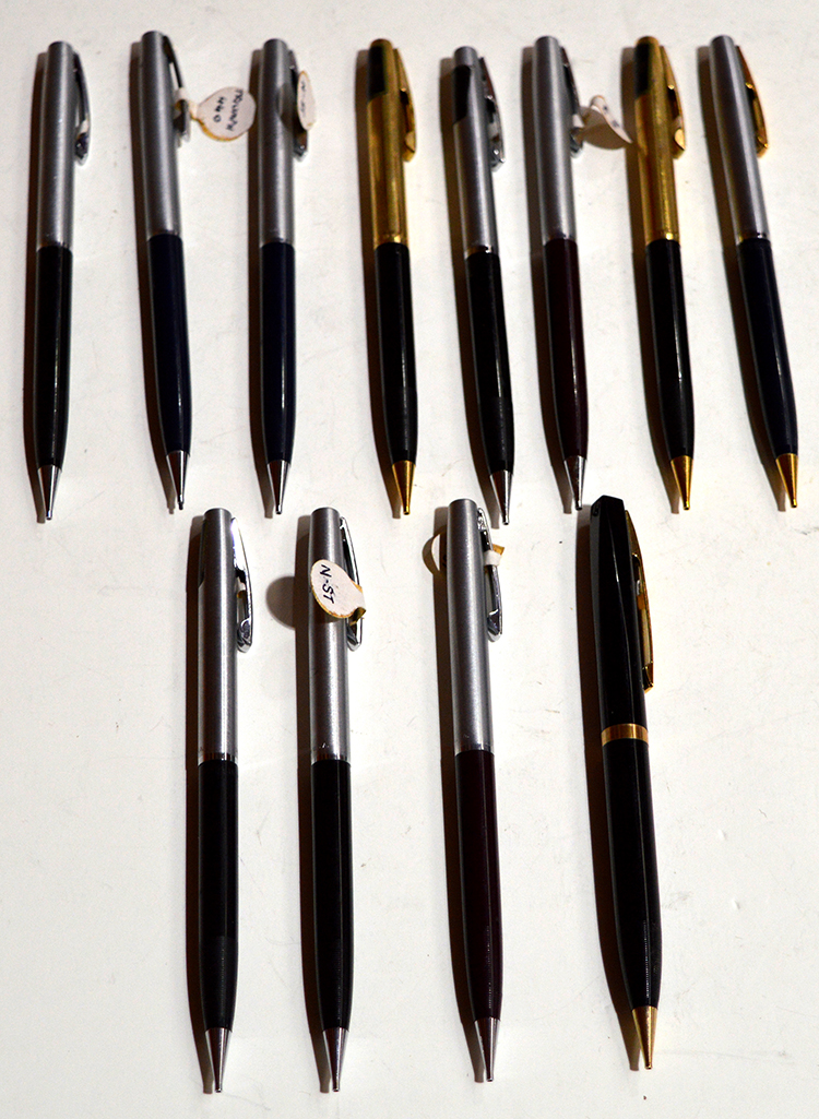 Eleven Sheaffer Triumph propelling pencils; together with another propelling pencil by Sheaffer.